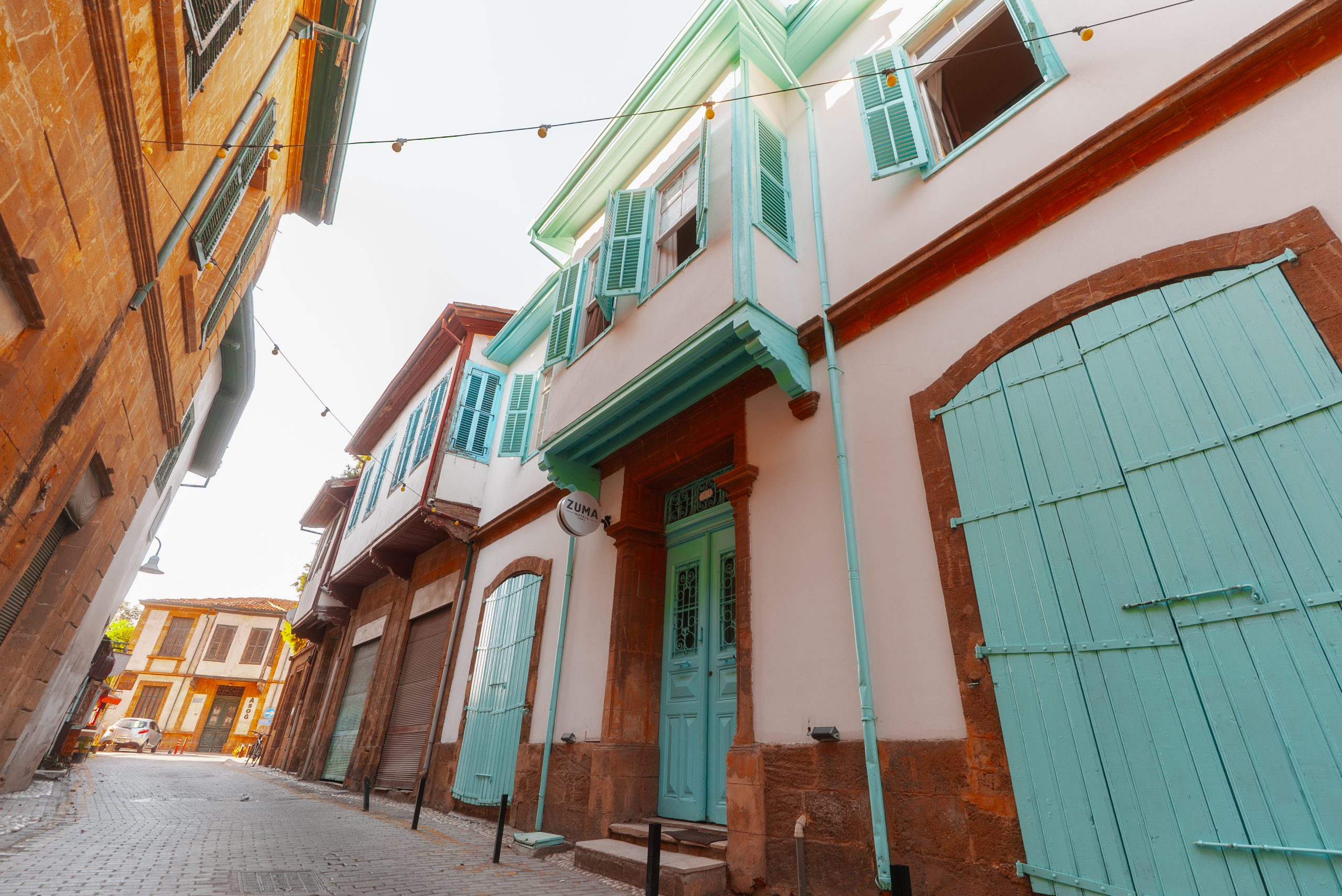 Turquoise shutters and timber balconies of Zuma Hotel's Ottoman mansion on an old Nicosia street